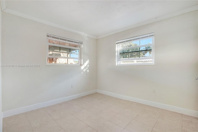 spare room featuring ornamental molding and plenty of natural light