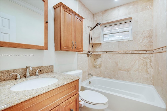 full bathroom with crown molding, tiled shower / bath, vanity, and toilet