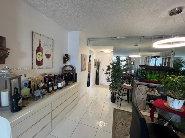 interior space with light tile patterned flooring and a textured ceiling