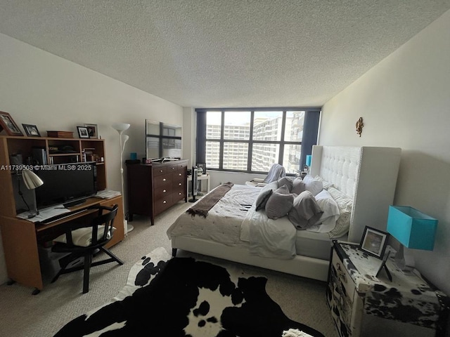 carpeted bedroom featuring a textured ceiling