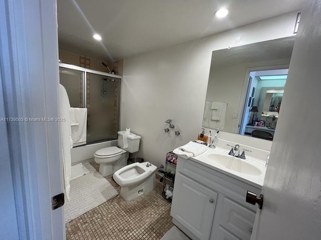 full bathroom featuring a bidet, combined bath / shower with glass door, vanity, tile patterned floors, and toilet