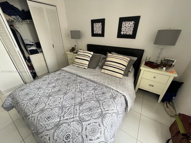 tiled bedroom with a closet