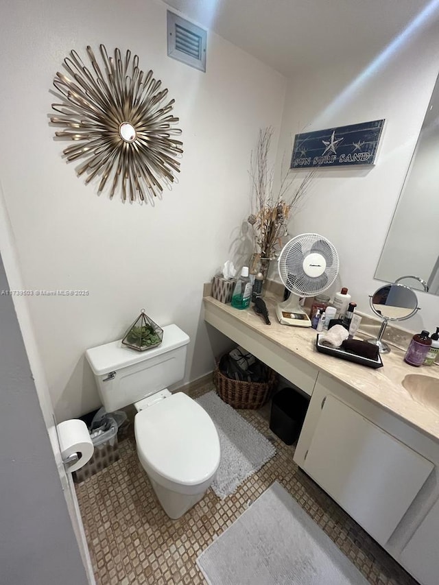 bathroom with tile patterned floors, vanity, and toilet