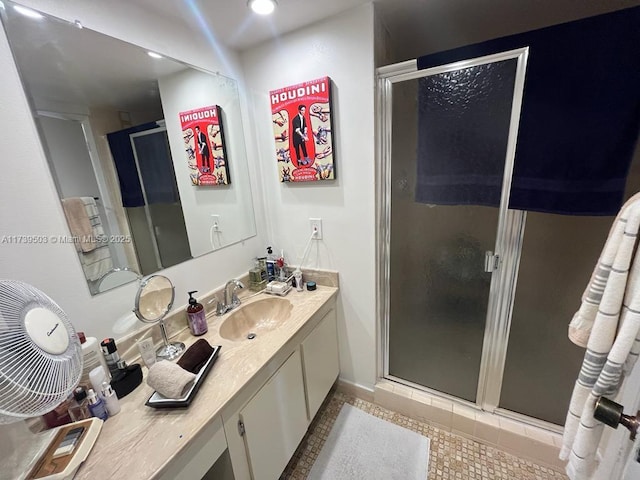 bathroom featuring vanity, tile patterned floors, and walk in shower