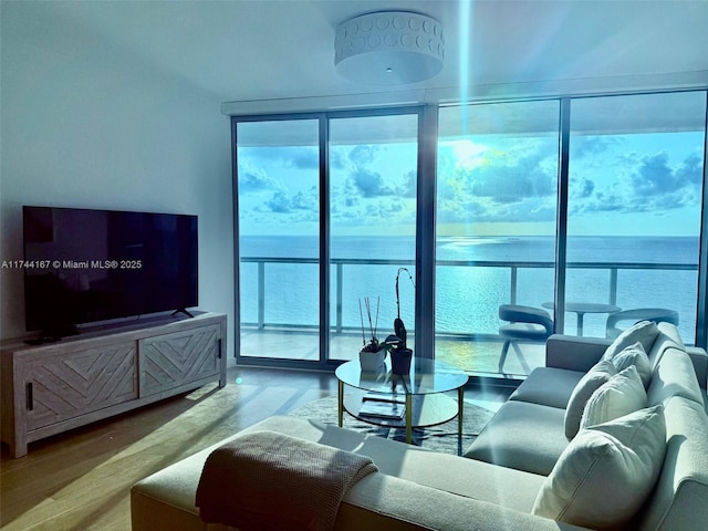 17001 Collins Ave Unit 2702, Sunny Isles Beach, FL 33160 - living room with plenty of natural light, wood finished floors, floor to ceiling windows, and a water view