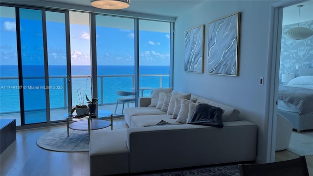 17001 Collins Ave Unit 2702, Sunny Isles Beach, FL 33160 - living room with expansive windows, healthy amount of natural light, a water view, and wood finished floors