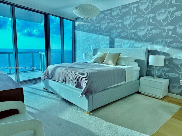 17001 Collins Ave Unit 2702, Sunny Isles Beach, FL 33160 - bedroom with wood finished floors, wallpapered walls, multiple windows, and baseboards