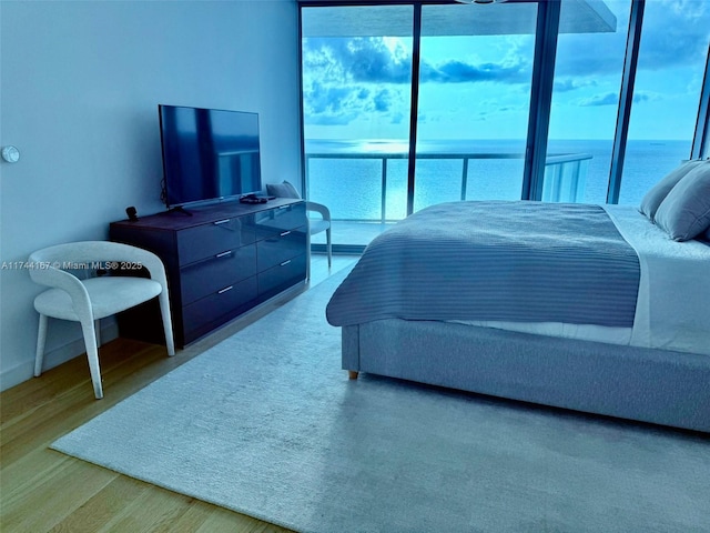 17001 Collins Ave Unit 2702, Sunny Isles Beach, FL 33160 - bedroom featuring multiple windows, wood finished floors, and baseboards