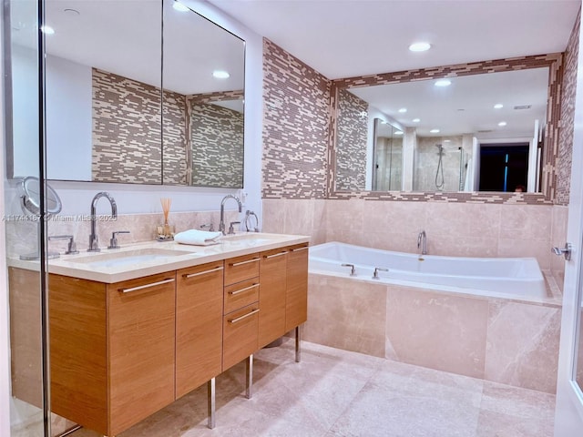 17001 Collins Ave Unit 2702, Sunny Isles Beach, FL 33160 - bathroom with tile walls, a garden tub, double vanity, recessed lighting, and an enclosed shower