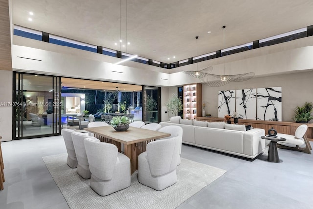 dining area with a towering ceiling