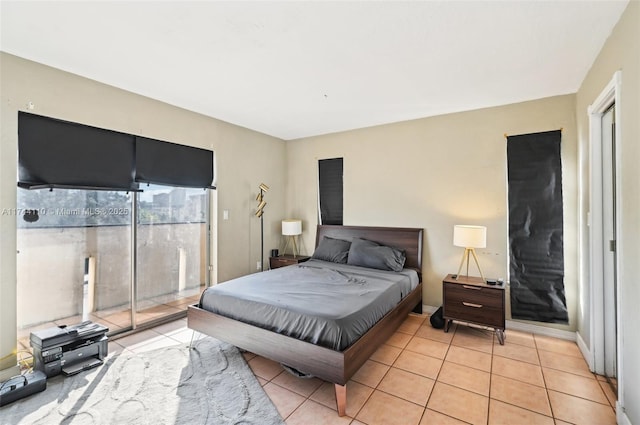 tiled bedroom with multiple windows and access to exterior