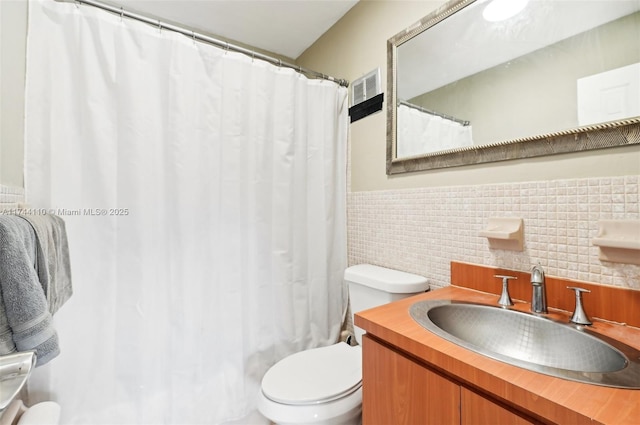 bathroom featuring a shower with curtain, vanity, toilet, and tile walls