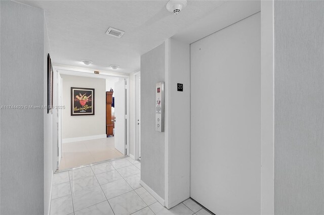 936 Intracoastal Dr Unit 20E, Fort Lauderdale, FL 33304 - hallway featuring elevator, visible vents, baseboards, and light tile patterned floors