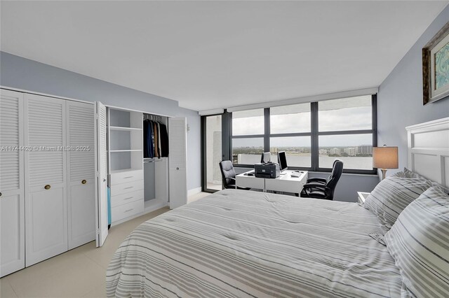 936 Intracoastal Dr Unit 20E, Fort Lauderdale, FL 33304 - bedroom featuring a wall of windows and two closets