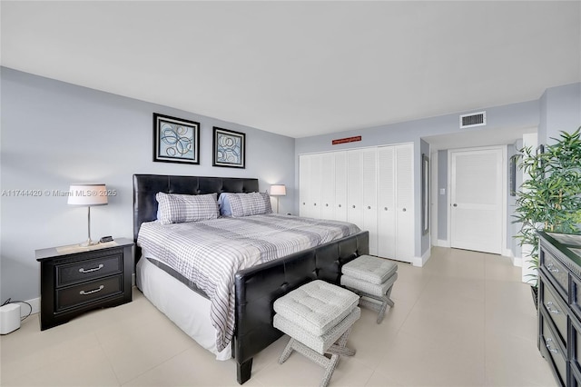 bedroom with light tile patterned floors and a closet