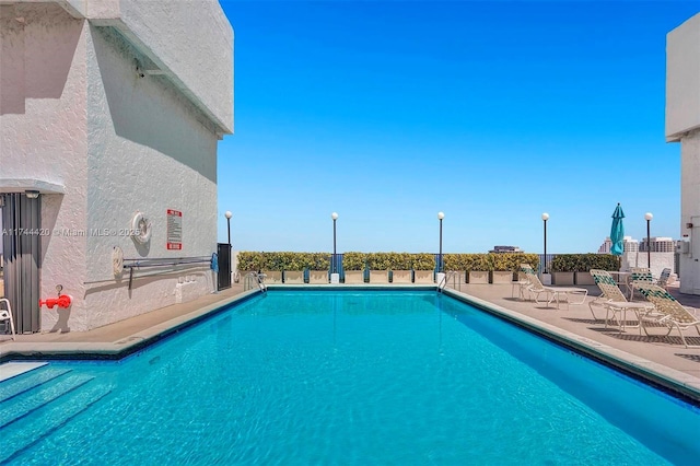 view of swimming pool with a patio area