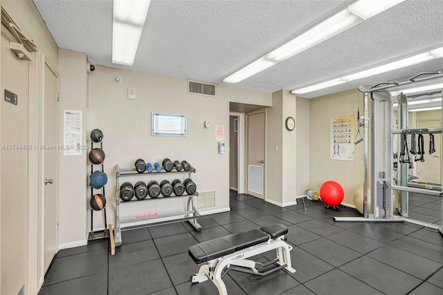 exercise room with a textured ceiling