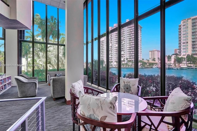 sunroom / solarium featuring a water view and plenty of natural light