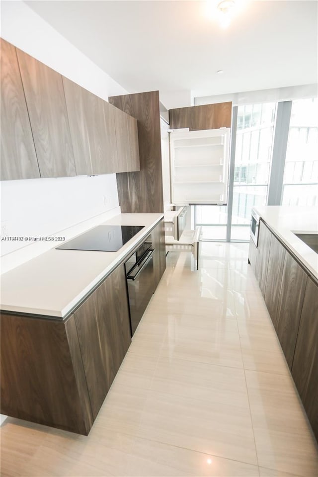 kitchen featuring black appliances and a kitchen island