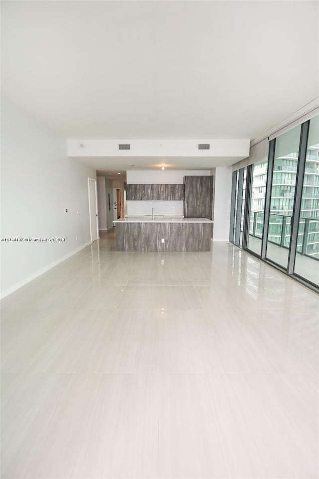 unfurnished living room featuring floor to ceiling windows