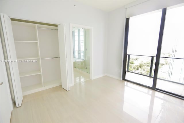 unfurnished bedroom featuring a closet and light wood-type flooring