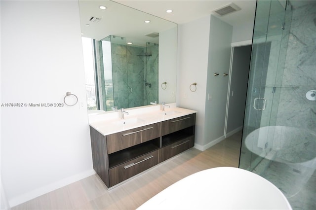 bathroom with vanity and a shower with shower door