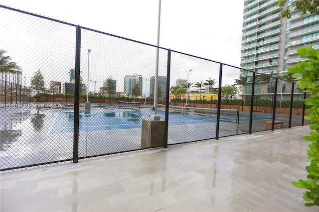 view of basketball court featuring tennis court