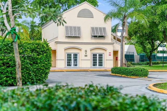 mediterranean / spanish-style house with french doors