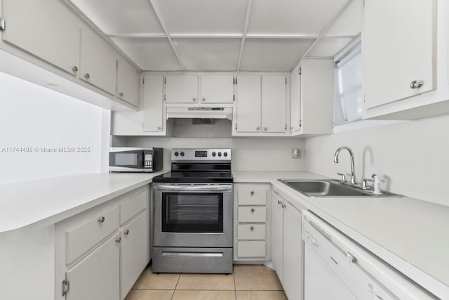 kitchen with light tile patterned flooring, sink, white cabinetry, a paneled ceiling, and appliances with stainless steel finishes