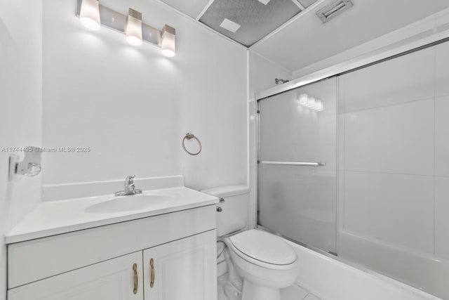 full bathroom featuring bath / shower combo with glass door, vanity, and toilet