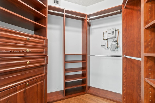 spacious closet featuring light wood-type flooring