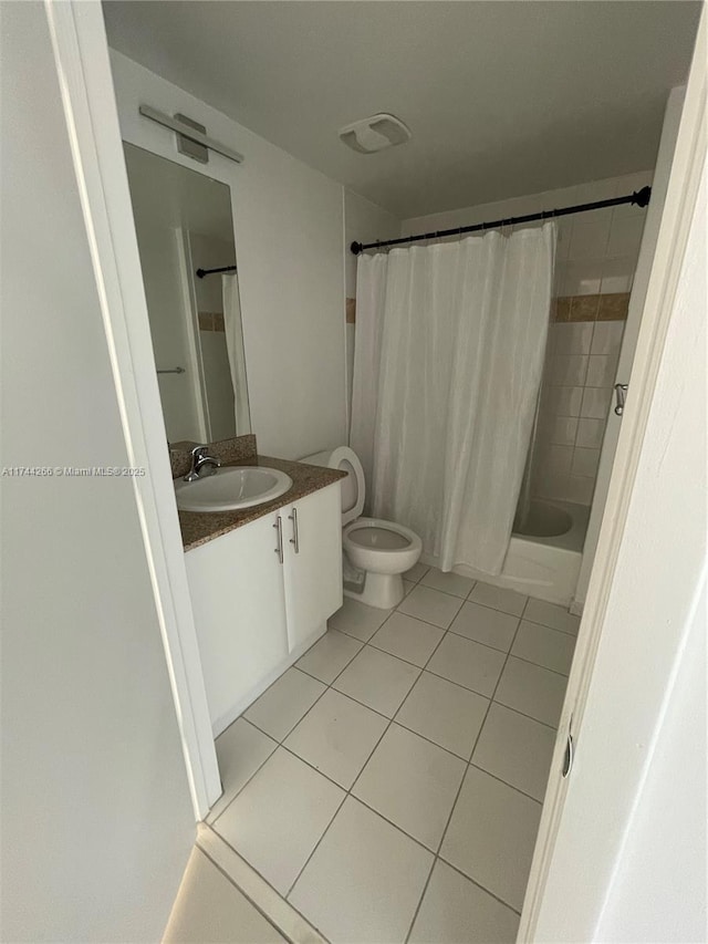 full bath featuring toilet, tile patterned flooring, shower / bath combo, and vanity