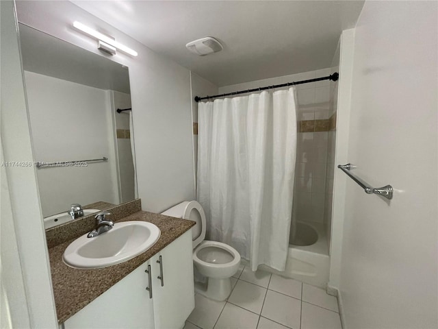 bathroom featuring vanity, toilet, shower / tub combo, visible vents, and tile patterned flooring