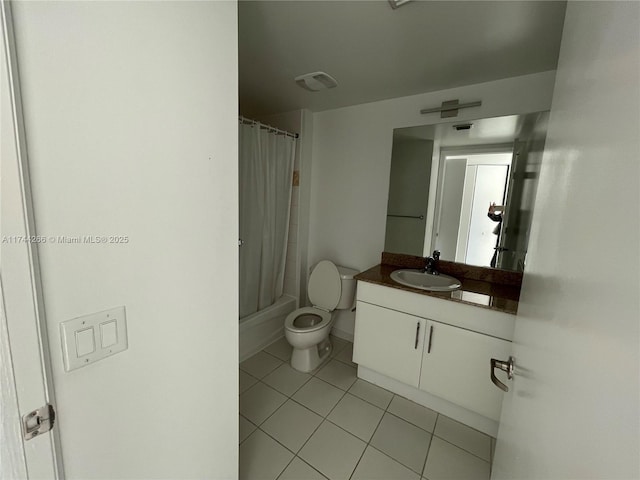 bathroom featuring shower / tub combo with curtain, toilet, tile patterned flooring, and vanity