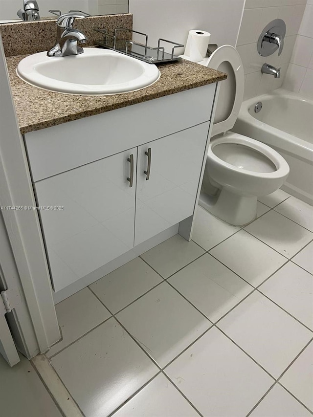 bathroom featuring toilet, shower / washtub combination, vanity, and tile patterned flooring