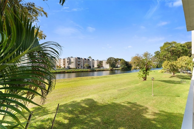 view of home's community featuring a yard and a water view