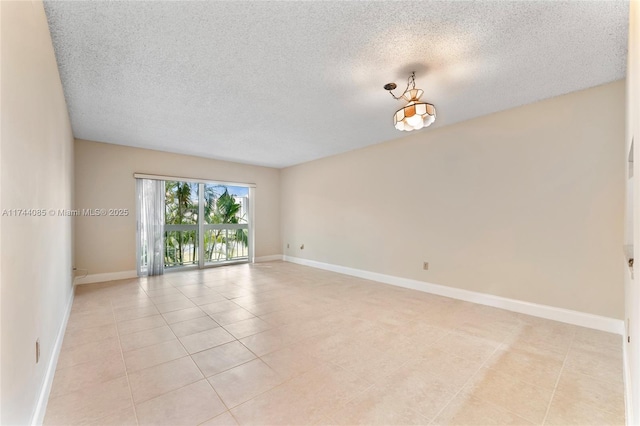 tiled spare room with a textured ceiling