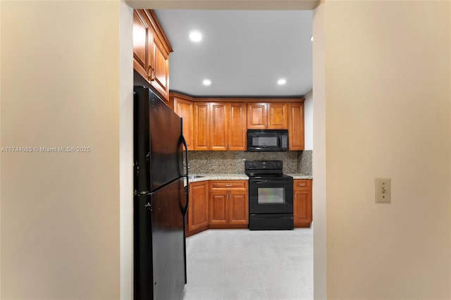 kitchen with tasteful backsplash and black appliances