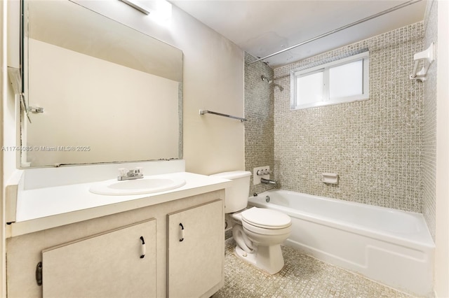 full bathroom with tiled shower / bath, vanity, tile patterned floors, and toilet