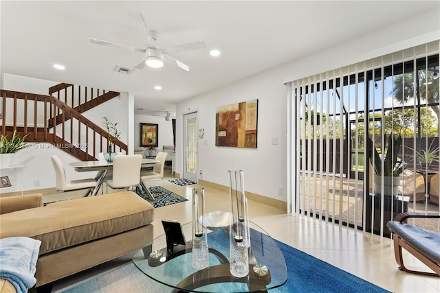 living room featuring ceiling fan and tile patterned flooring