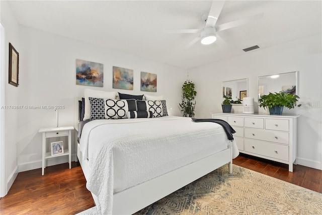 bedroom with dark hardwood / wood-style floors and ceiling fan