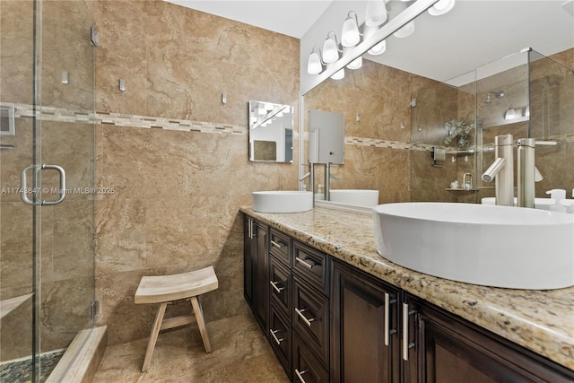 bathroom featuring tile walls, vanity, and an enclosed shower