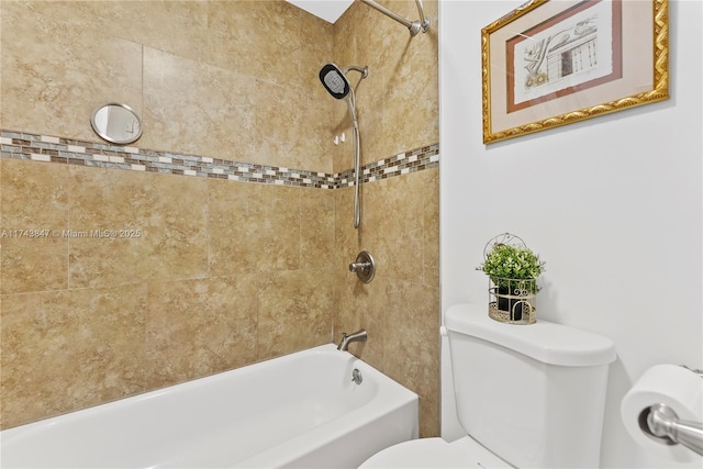 bathroom with tiled shower / bath and toilet