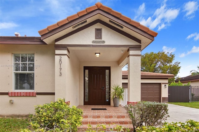 view of exterior entry featuring a garage