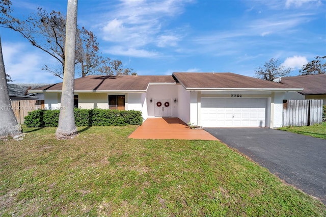 view of front of home featuring a garage and a front lawn