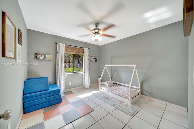 bedroom featuring light tile patterned flooring and ceiling fan