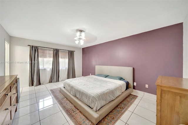 tiled bedroom featuring ceiling fan