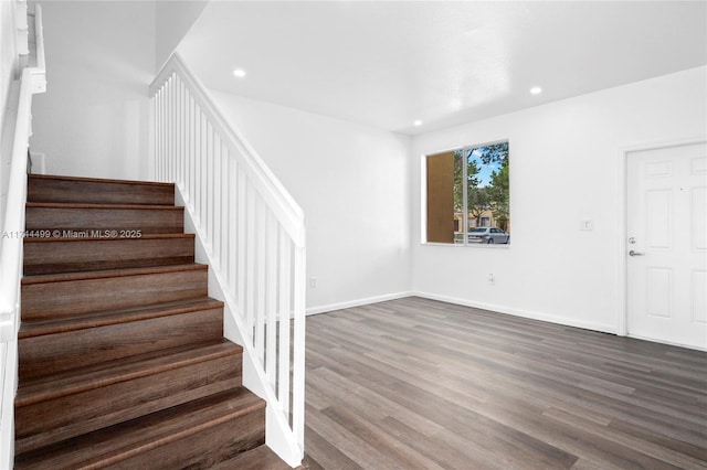 staircase with hardwood / wood-style floors