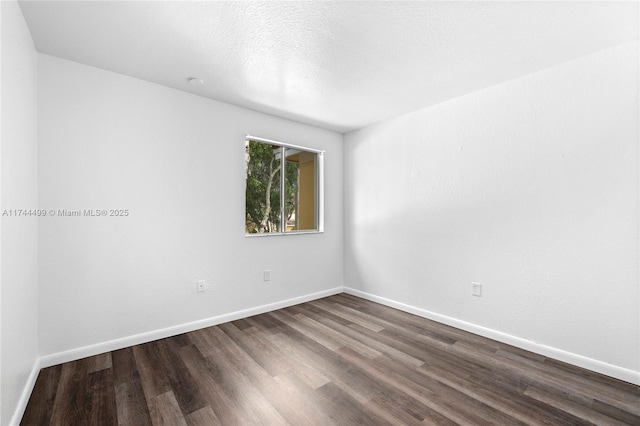 spare room with hardwood / wood-style flooring and a textured ceiling