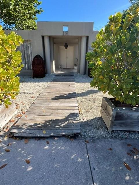 doorway to property with stucco siding